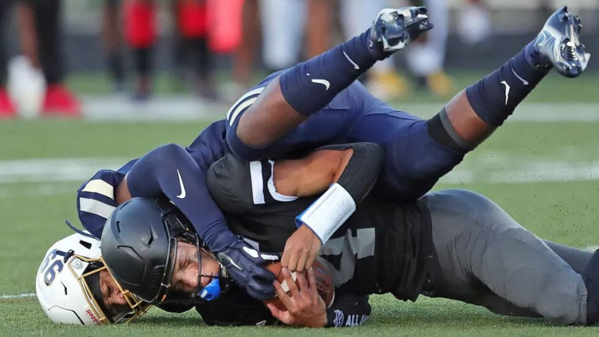Bishop Sycamore’s quarterback is tackled by a defender from Archbishop Hoban.